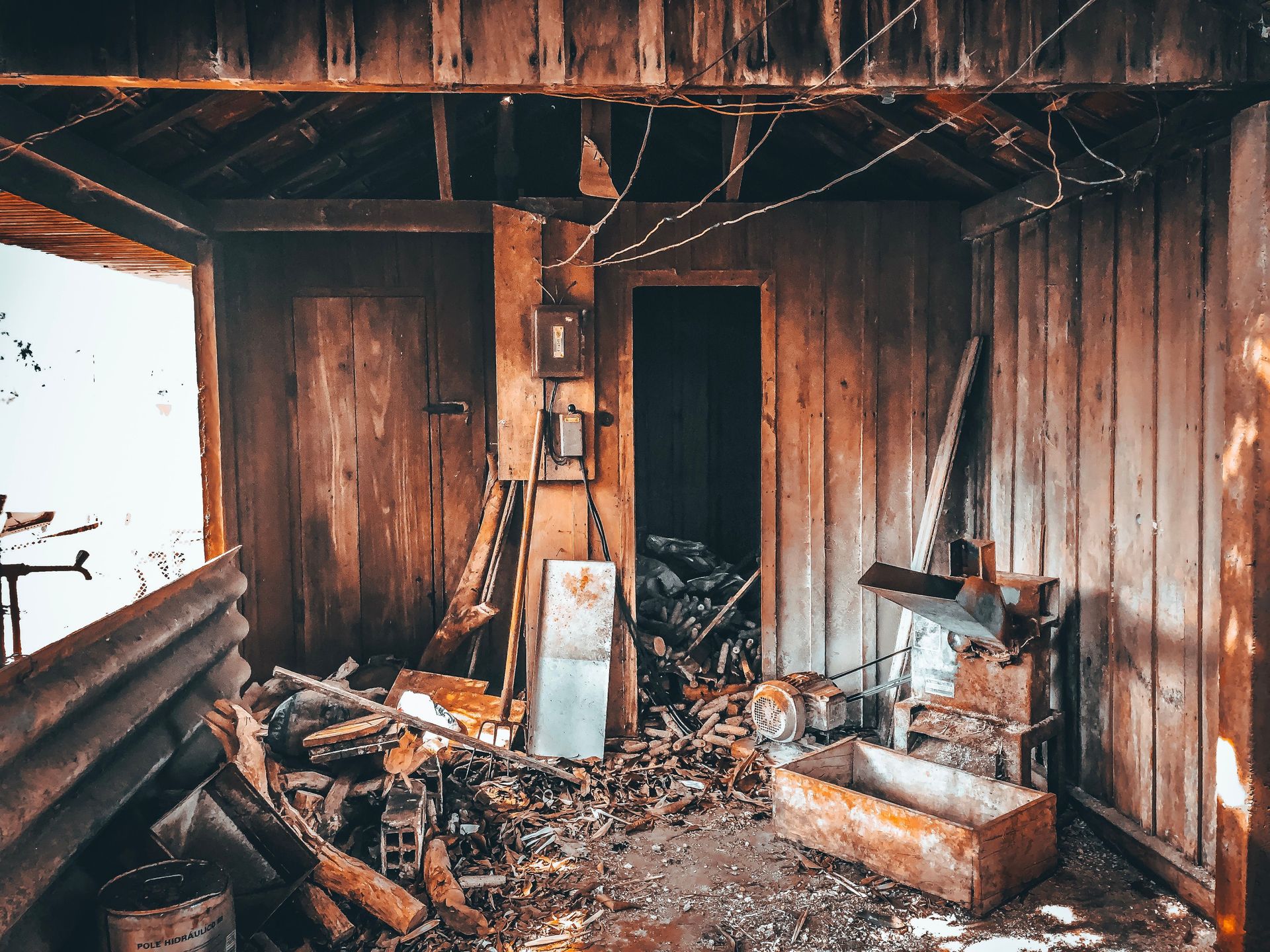Explore the decay of a rustic wooden shed with broken tools and abandoned materials strewn about.
